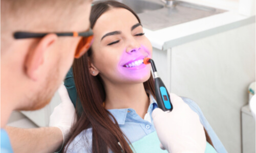 woman laser teeth whitening procedure